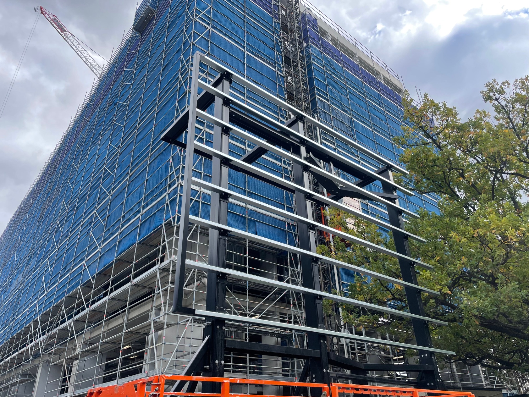 Freestanding steel frame erected at building corner