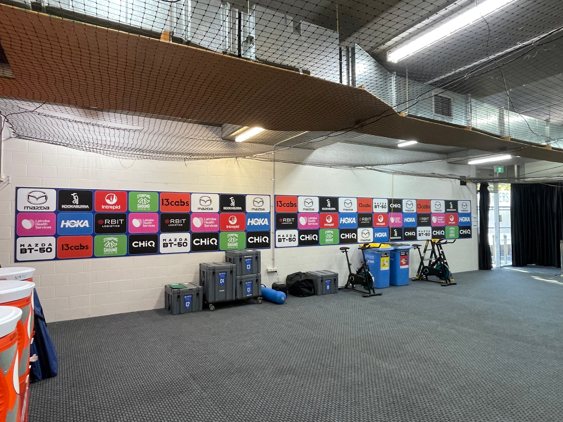 Multi-panel sponsor install along equipment storage wall