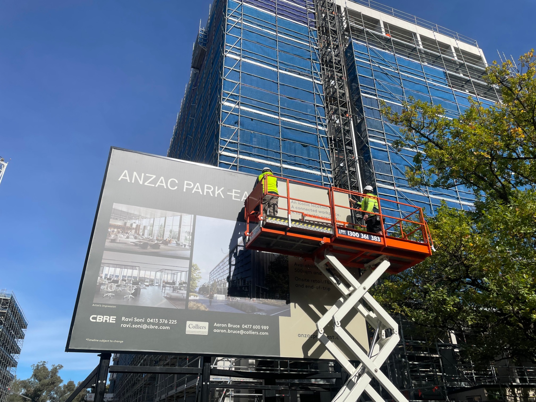 Skinning the Anzac Park East billboard from scissor lift