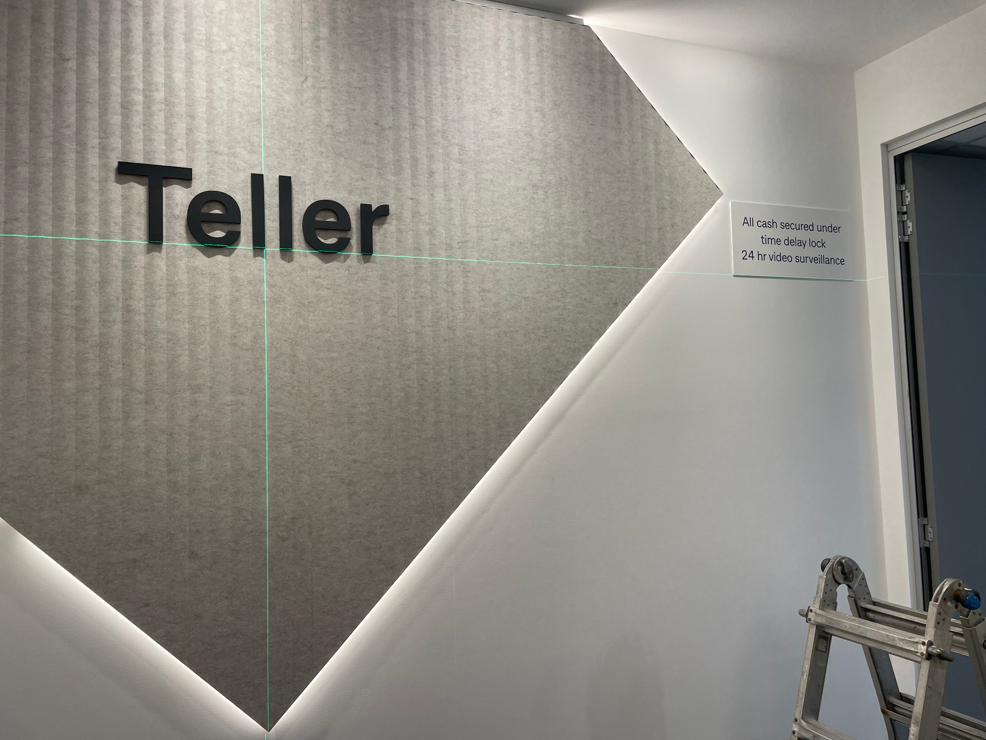 Teller feature wall — dimensional letters set to laser line