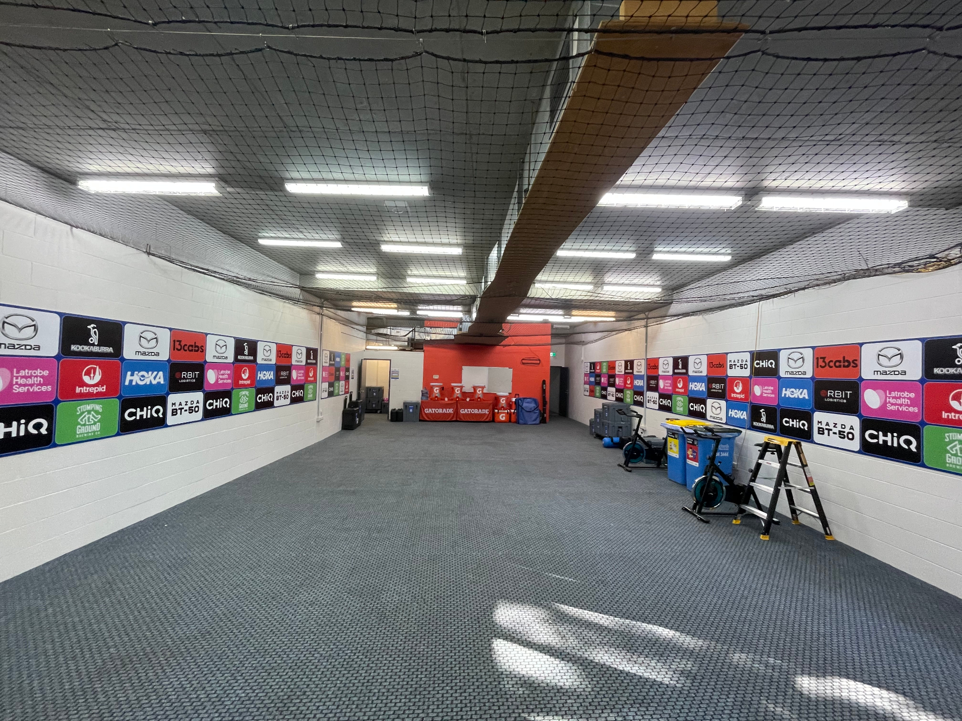 Player warm-up room with full sponsor board runs on both walls