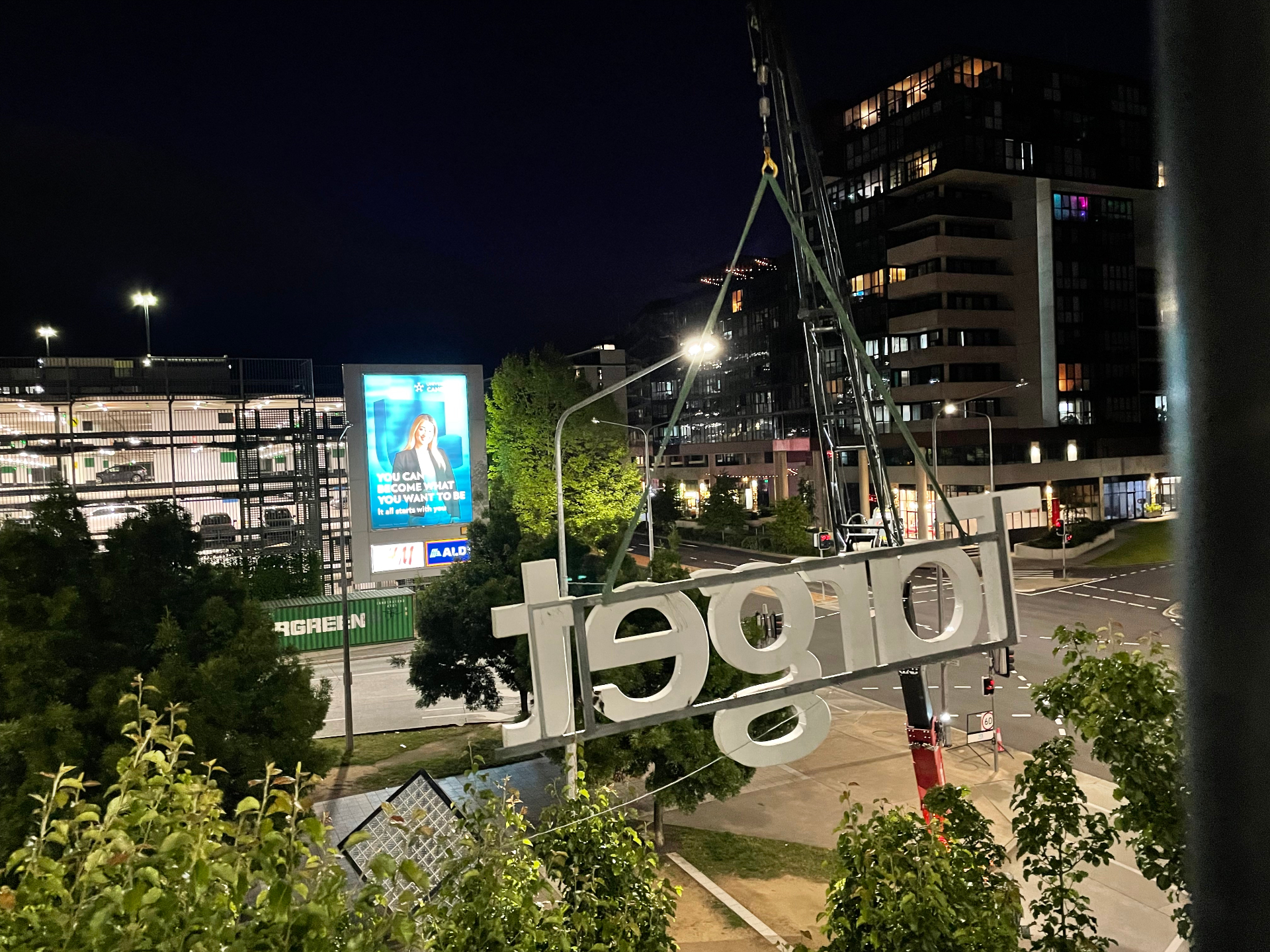 Letter set craned across the street under traffic management