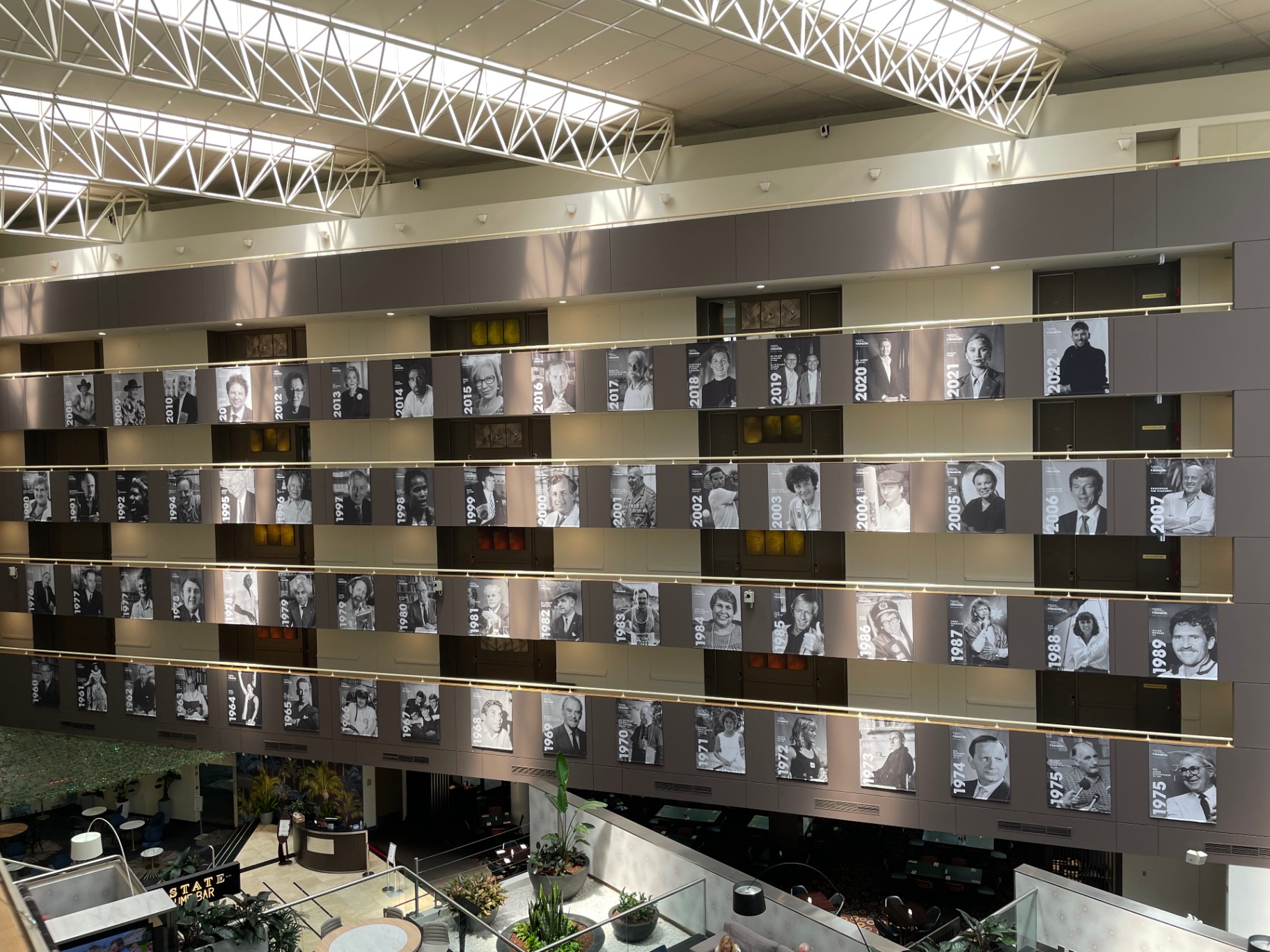 Tensioned recipient banners aligned across the atrium wall