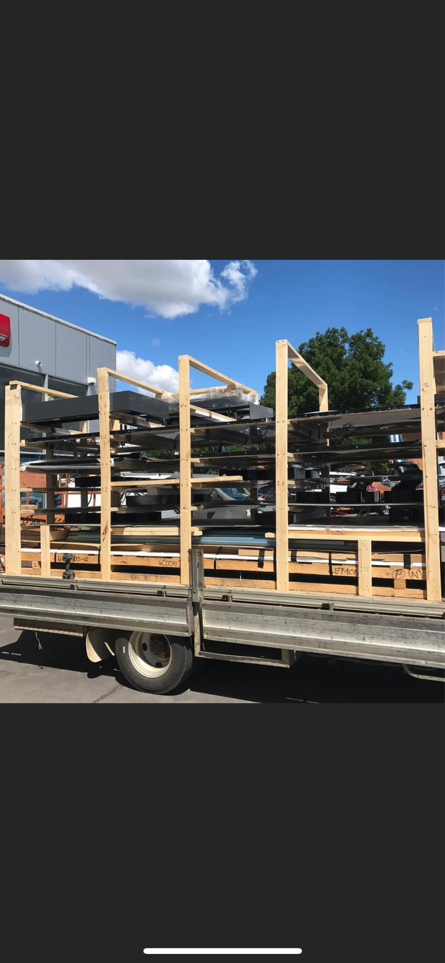 Crated sign panels staged on truck for site delivery