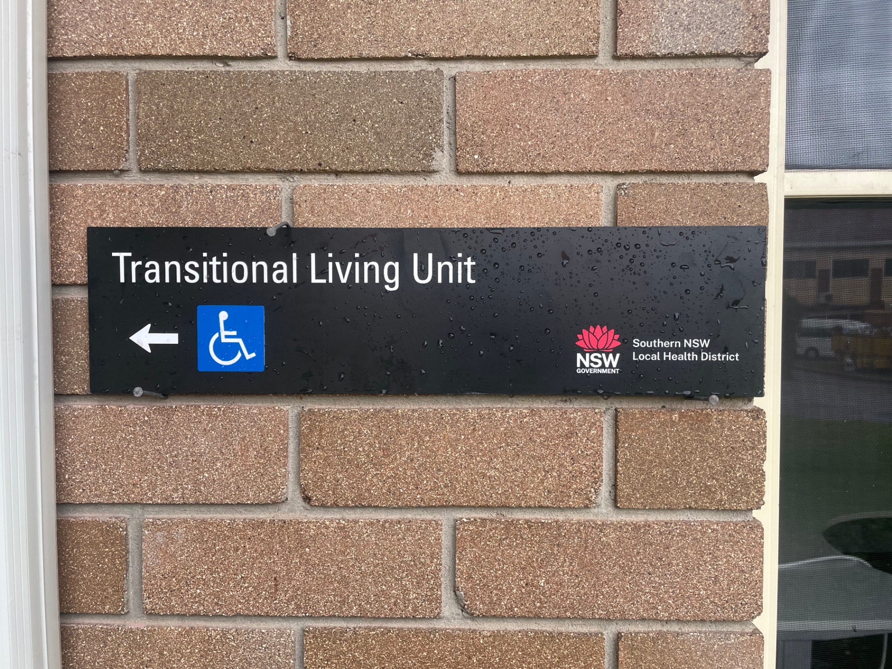 NSW-branded directional plate
