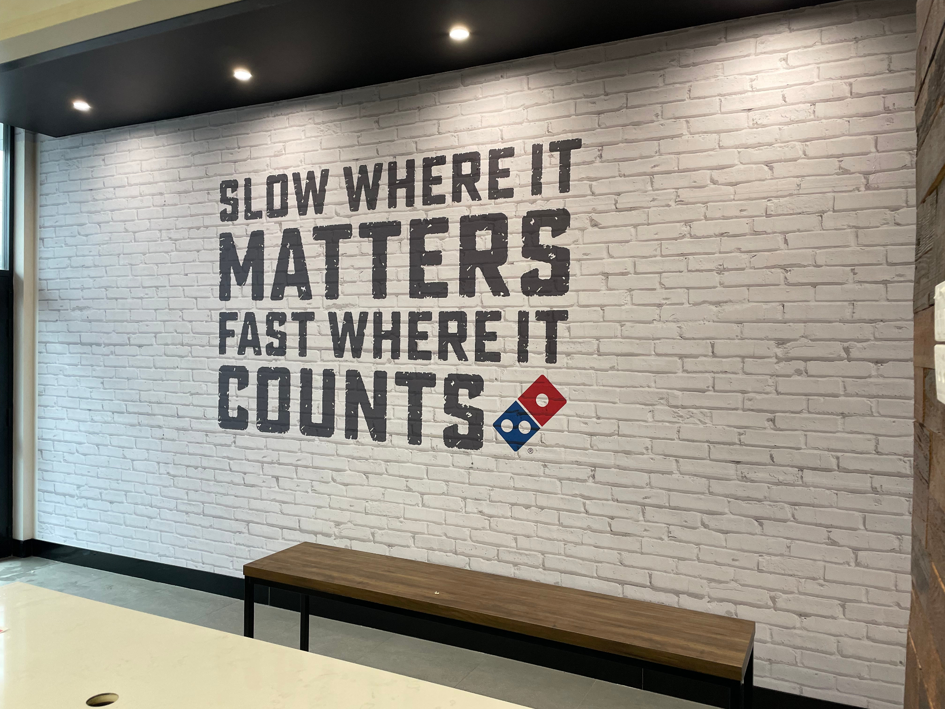 Finished brick-look brand wall mural in customer area
